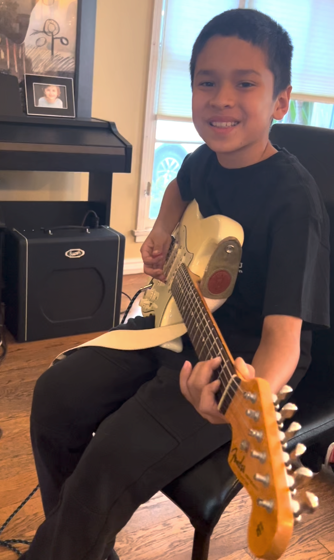 Young guitar student Cass during a lesson at Matt Rosenfeld's studio