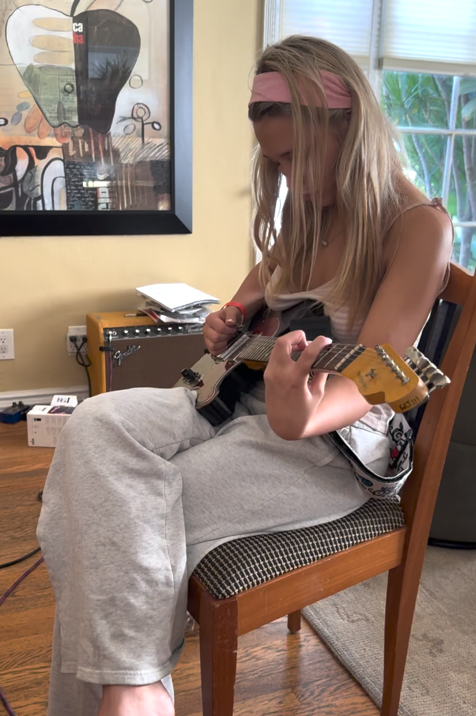 Guitar student Natalie, known for exceptional rhythm and tone, at the studio